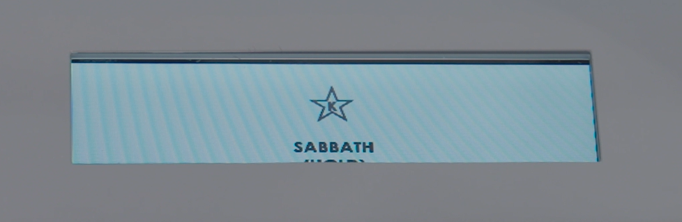 A rectangular sign displays a star icon above the word "SABBATH" in capital letters on a light blue background.