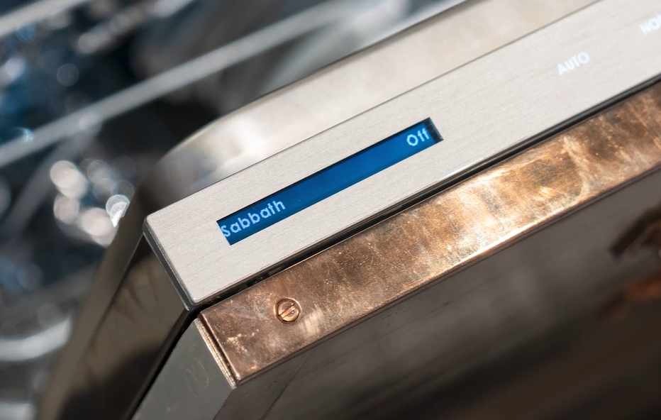 Close-up of a dishwasher control panel displaying "sabbath" mode and "off," with an open dishwasher rack visible in the background.